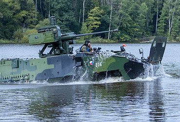 Soldiers from the 4th Rapid Deployment Brigade float across the water with Pandurs